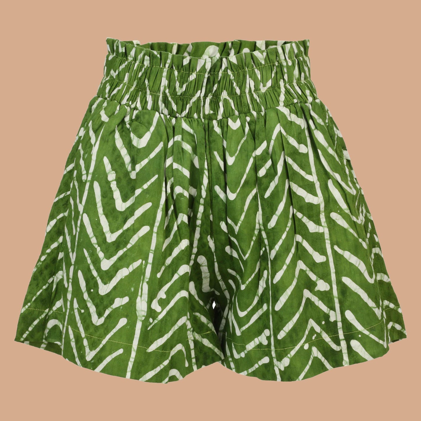 Model wearing Nro Àdìrẹ Hand Dyed Shorts – green high-waist African print cotton shorts with side pockets and elastic waistband.