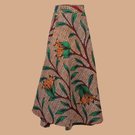 Model wearing Flora Reversible Wrap Skirt – high-waisted African print maxi skirt with tie waist and black reverse side, handmade in Nigeria